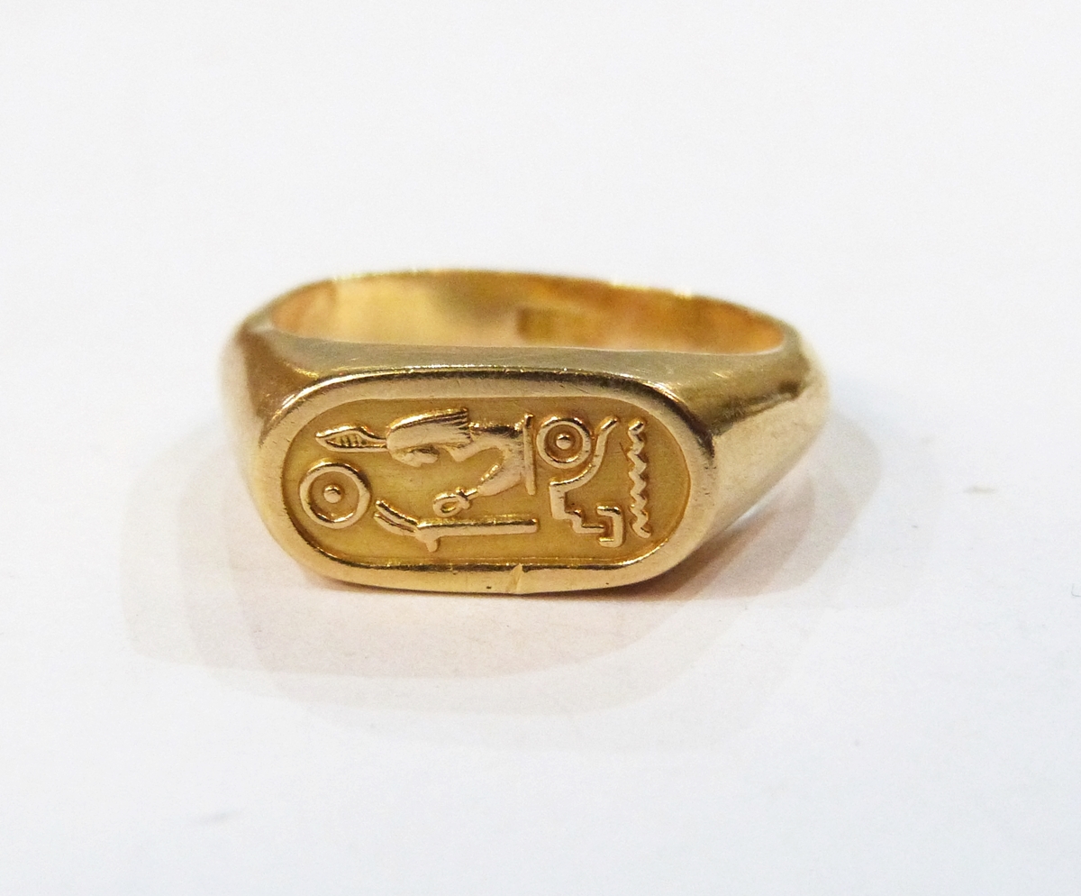 Egyptian gold-coloured ring of signet ring design decorated with ...