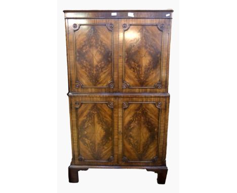 Reproduction mahogany drinks cupboard with panelled cupboard above and below, on bracket feet, 83cm wide 