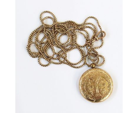 Gold-coloured metal circular locket pendant, engine-turned and engraved with floral sprays and pillar, opening to reveal plai