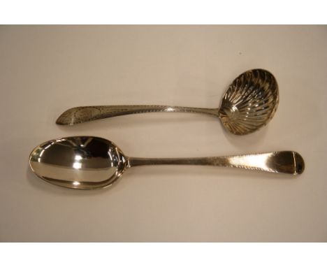 A George III Irish silver sauce ladle, having bright cut foliate decoration and family crest depicting a seated stag, Dublin 