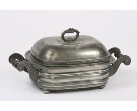An early 19th Century tureen, having detachable liner flanked by turned wooden handles, the domed lid surmounted by a leaf de
