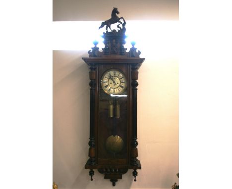 A late 19th Century walnut and ebonised regulator wall clock, the pediment surmounted by a rearing horse above horseshoe, joc