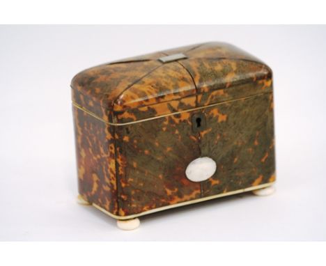 An early 19th Century tortoise shell and ivory tea caddy, of rectangular form, having white metal cartouche, raised on bun fe