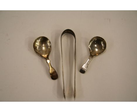 A Georgian silver caddy spoon; a modern Queen Elizabeth II caddy spoon; and a pair of 19th Century bright cut decorated sugar