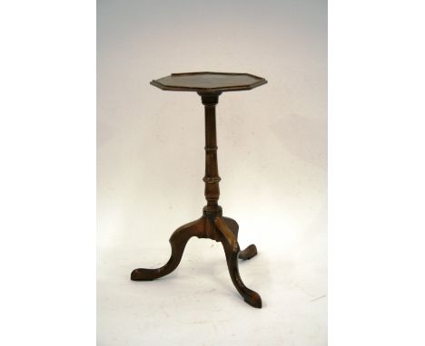 A 19th Century mahogany wine table, having octagonal top, raised on a turned baluster column and tripod base