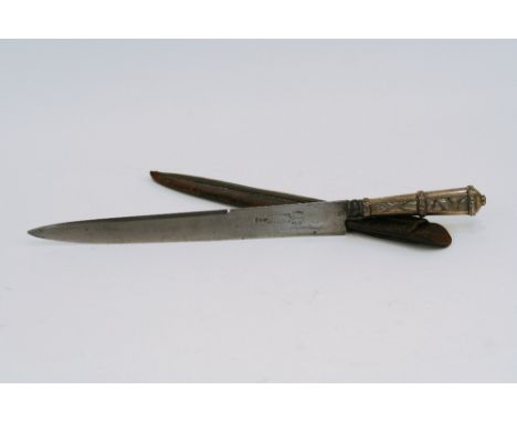 A 19th Century Uruguayan hunting knife, with foliate embossed white metal handle, in leather scabbard, 36cm long overall