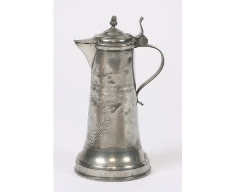 A German lidded flagon, having tapering body with wriggle work decoration, engraved K.W.R angular spout, the lid surmounted b
