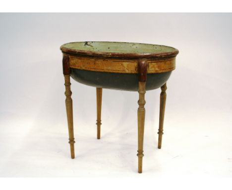 A 19th Century faux painted oval tin ware planter, raised on  turned tapering wooden supports, 73cm