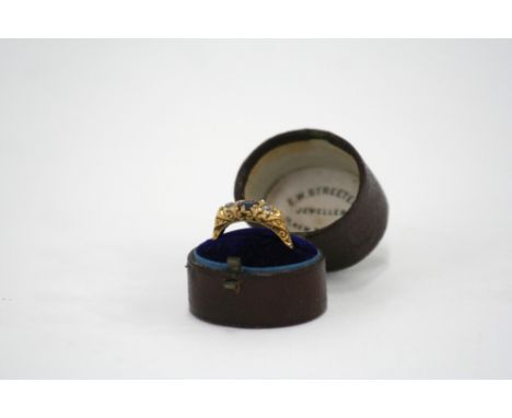 An 18ct gold three stone sapphire and diamond ring