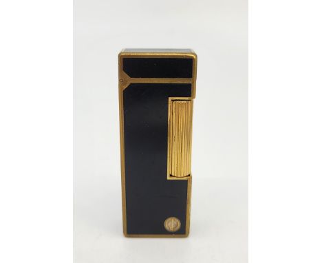A Dunhill gilt metal and black enamel Rollagas cigarette lighter.&nbsp;