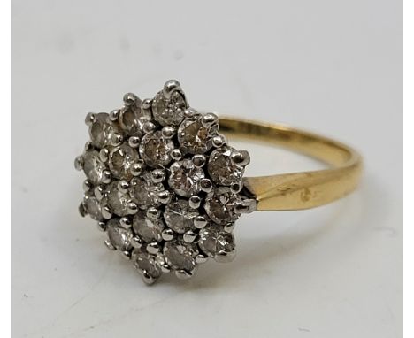 An 18ct. gold diamond cluster ring, having domed hexagonal mount pave set twenty-one round brilliant cut diamonds, size UK L 