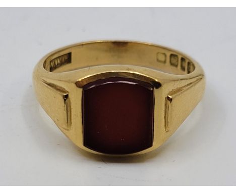 An 18ct. gold and carnelian signet ring, London 1958, size UK X 1/2. (gross weight 10.5g)