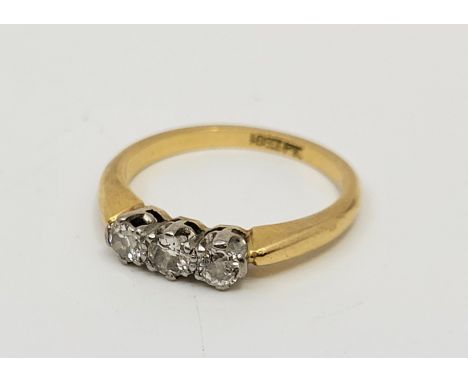 An 18ct. gold and platinum three stone diamond ring, set three round brilliant cut diamonds (ETDW 0.45 carats), size UK N 1/2