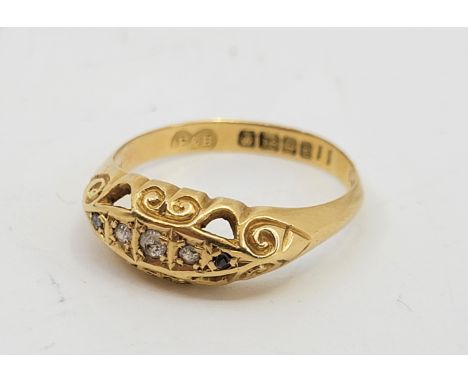 An 18ct. gold five stone diamond ring, Birmingham 1918, set three graduated eight-cut diamonds to centre and two smaller rose