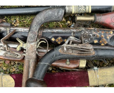 An interesting collection of flintlock guns to include a Kazak Rifle powder flask , sword stick and others   Additional image