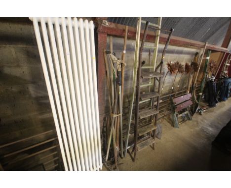 A quantity of various long handled tools to include garden hoe, rake, branch loppers etc.