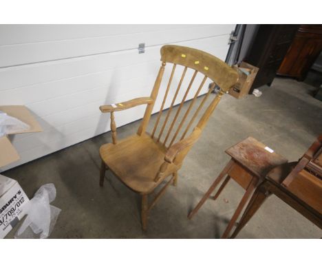A Victorian elm seated stick back elbow chair