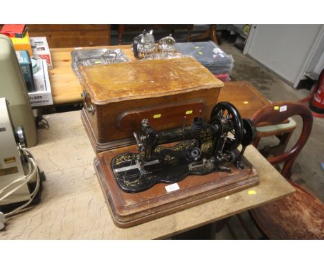 A vintage sewing machine in wooden case