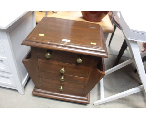 A painted magazine rack fitted three drawers, cupboard to base 