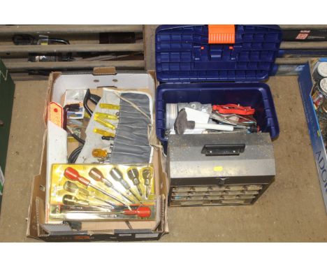 A tray box containing various tools to include part spanner set, screw drivers, warning triangle, saws, jump cables; and a pl