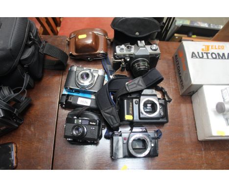 A Nikon camera body, a Minolta camera body, and various other cameras 