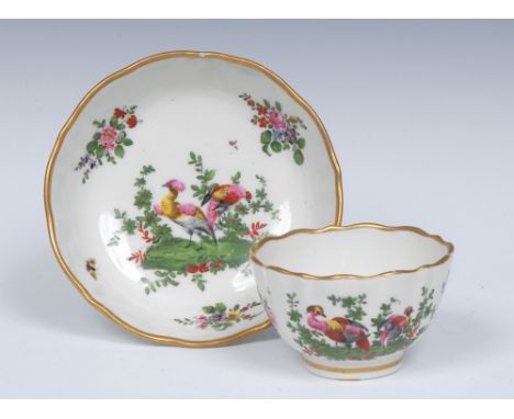 A Caughley fluted tea bowl and saucer, with Fancy Birds, in a garden setting, the verso with bird in branches, the rims with 