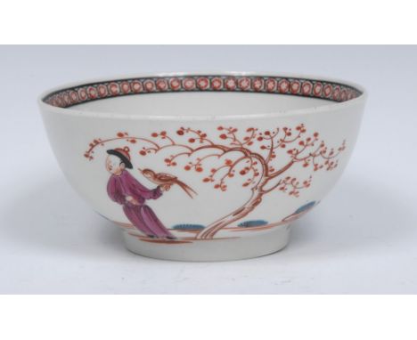A Worcester Mandarin style slop bowl, decorated with a Chinese figure holding a bird below a berried tree, the verso with thr