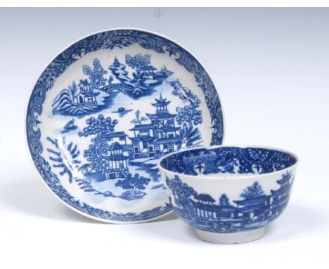 A Worcester Bandstand pattern tea bowl and saucer, printed and washed in blue with pagodas, trees, bridge and foliage, elabor