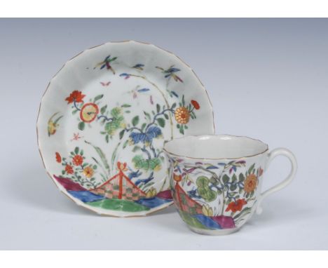 A Worcester Chequered Tent pattern Warmestry fluted shape coffee cup and saucer, decorated with an exotic garden scene with e