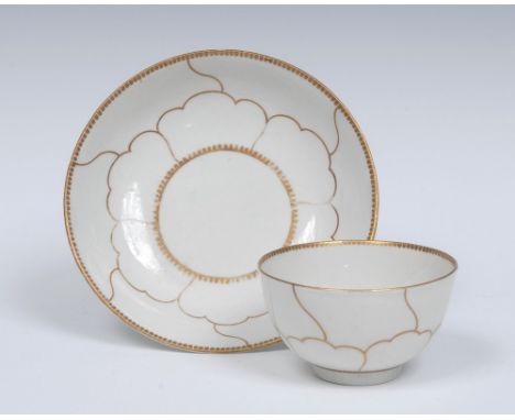A Worcester Gold Queens pattern tea bowl and saucer, decorated by James Giles, the centre with circular cartouche, the ground