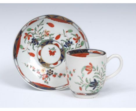 A Worcester  Kempthorne pattern coffee cup and saucer, grooved handle, painted with stylised flower sprays in underglaze blue
