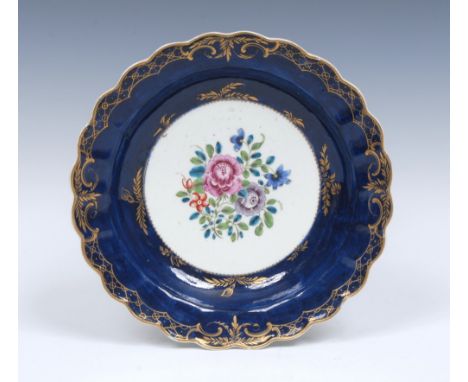 A Worcester lobed desert plate,  decorated to the centre with a bouquet  of flowers on a wet blue ground,  fancy edged gildin