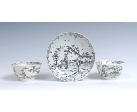 A rare Worcester tea bowl and saucer, pencilled in black with a Chinoiserie scene with  a man holding a parasol and  bird, by