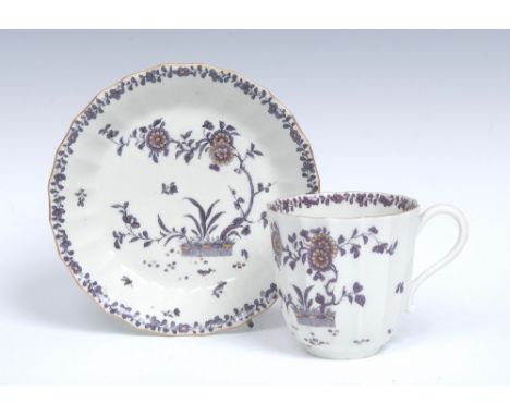 A Worcester fluted coffee/chocolate cup and saucer, of large size,  scroll handle, painted in very dark purple with flowering