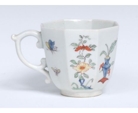 A  Worcester octagonal coffee cup, delicately painted with a Chinese gentleman standing by a pedestal, flanked by two flower 