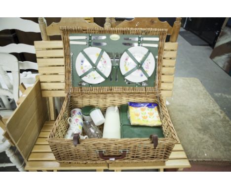 A WICKER PICNIC HAMPER FITTED WITH CONTENTS, FOR FOUR PERSONS AND A COLLAPSIBLE PICNIC TABLE AND TWO CHAIRS 
