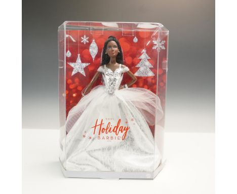 Presented in its original festive collector's box, this Barbie doll celebrates the season in a shimmering white gown with sil