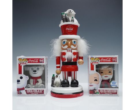 3-piece Coca-Cola Collection including two Funko Pop! Ad Icons figurines and a Coca-Cola themed nutcracker. The lot includes 
