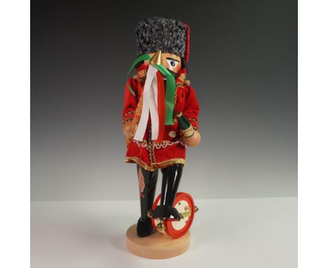 Handcrafted wooden nutcracker by Steinbach, depicting a Musical Hungarian figure dressed in a red velvet coat with gold trim,