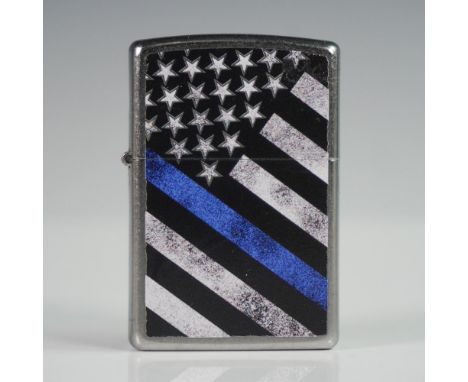 Official Zippo windproof lighter featuring a stylized American flag design in black and white with a bold Thin Blue Line, sym