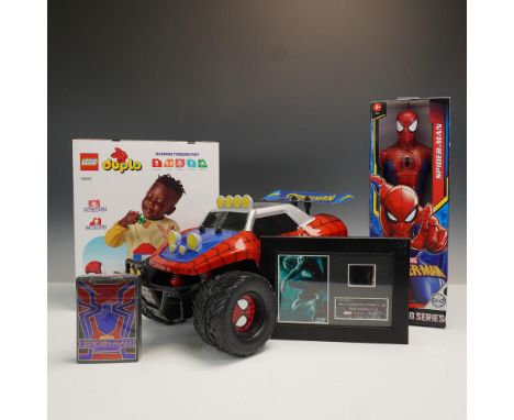 Collection of five Marvel Spider-Man themed toys and entertainment memorabilia. Includes a Hasbro Titan Heroes Series Spider-