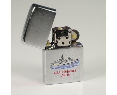 Zippo silver-tone metal lighter featuring an illustration of the U.S.S. Pensacola LSD-38 naval vessel. Manufactured by Zippo 