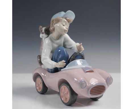 Lladro figurine titled Out for a Spin, model 01005770, sculpted by Joan Coderch. Issued in 1991 and retired in 1994, this pla