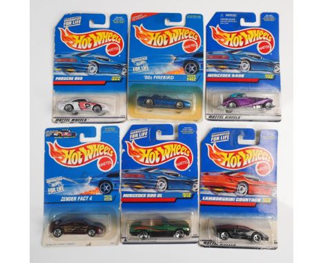 Six vintage Hot Wheels die-cast model cars, each sealed in its original Mattel packaging with collector numbers and "Guarante