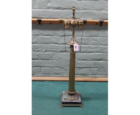 A tall brass finish Corinthian column double lamp on stone base, 70cm high (wear to finish, previously wired for electric)