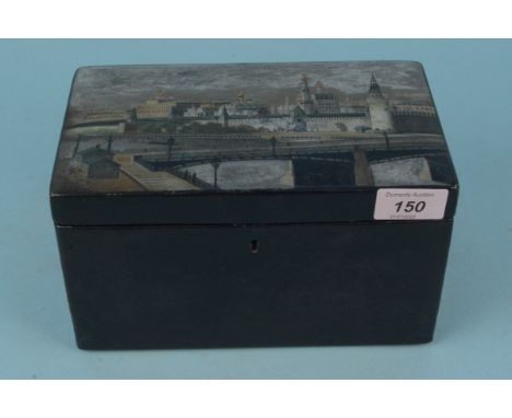 A late 19th Century Russian painted lacquer tea caddy, the lid decorated with a hand painted view of the Kremlin in the manne