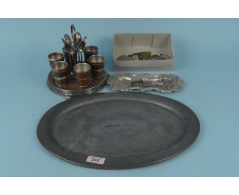 An oval pewter tray, an oak and plated egg stand with six oak and plated egg cups, a plated candle snuffer and tray plus asso