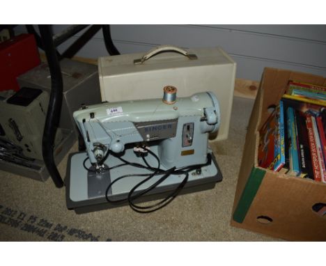 A vintage Singer sewing machine, model number 357K, with case.