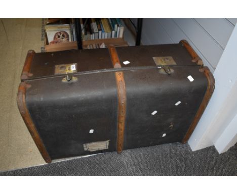 A vintage wooden bound steamer trunk, Isle of Man Steam Packet Company label to side.