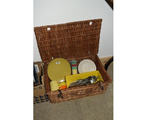 A vintage wicker picnic basket including Melaware plates, assorted cutlery etc
